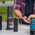 Portable coffee-making equipment on a park bench.