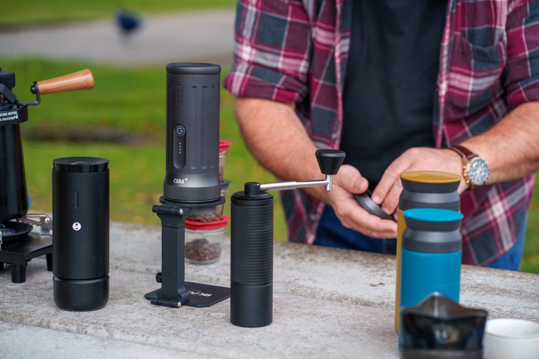 Portable coffee-making equipment on a park bench.